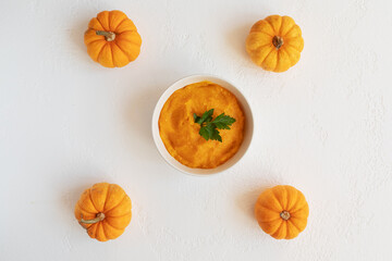 orange pumpkin soup on white table