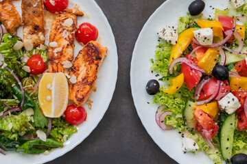 top view of two greek salads with olives and feta cheese and fried salmon