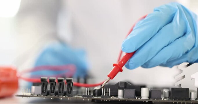 Master wearing rubber gloves examining computer motherboard with tester closeup 4k movie slow motion