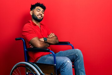Arab man with beard sitting on wheelchair happy face smiling with crossed arms looking at the...