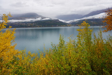 autumn landscape  in the mountains with serre ponçon  lake southern alps france on foggy day