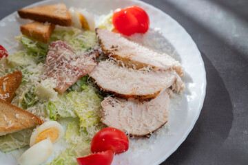 Caesar salad dish with chicken and lettuce