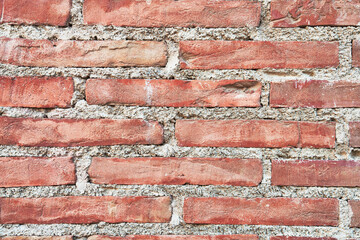 Brick wall texture with cracked tiles and cement. Classic brickwall surface background