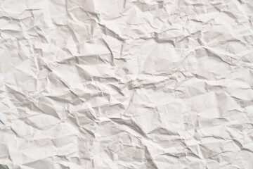 White crumpled paper texture with wrinkles. Damaged and torn sheet