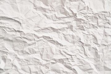 White crumpled paper texture with wrinkles. Damaged and torn sheet