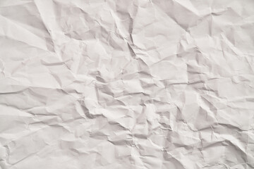 White crumpled paper texture with wrinkles. Damaged and torn sheet