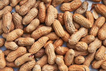 Healthy roasted unpeeled peanuts. Brown nuts texture