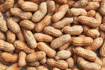 Healthy roasted unpeeled peanuts. Brown nuts texture