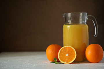 orange juice in jar and oranges