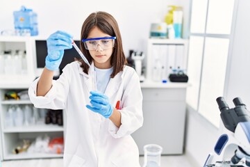 Young hispanic girl working at laboratory