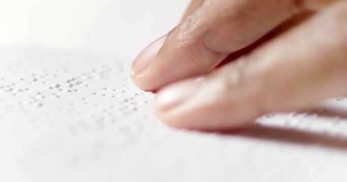 A finger is reading braille