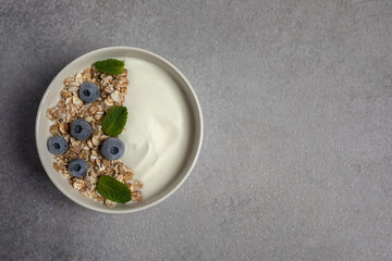 blueberries in a bowl. breakfast with fruits. Yoghurt with granola.