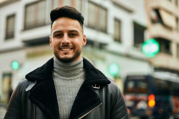 Young arab man smiling happy standing at the city.