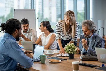 Shot of a group of businesspeople having a meeting in a modern office. Shot of a group of businesspeople sitting together in a meeting. Team of professionals discussing over new business project