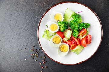 salad vegetables and egg, broccoli, tomato, cucumber, meal snack on the table copy space food background keto or paleo diet