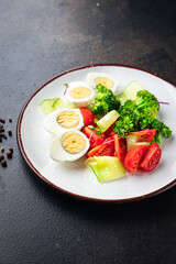 salad vegetables and egg, broccoli, tomato, cucumber, meal snack on the table copy space food background keto or paleo diet