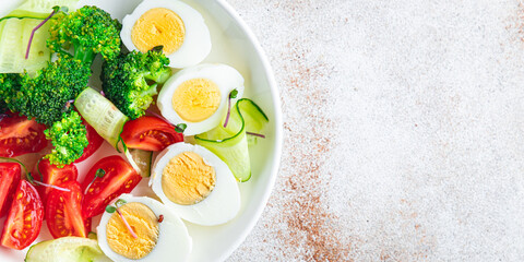 salad vegetables and egg, broccoli, tomato, cucumber, meal snack on the table copy space food background keto or paleo diet