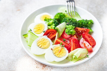 salad vegetables and egg, broccoli, tomato, cucumber, meal snack on the table copy space food background keto or paleo diet