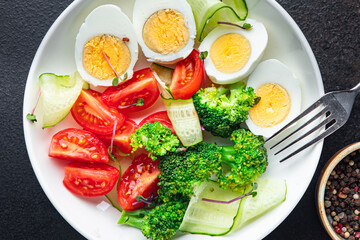 salad vegetables and egg, broccoli, tomato, cucumber, meal snack on the table copy space food background keto or paleo diet