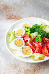 salad vegetables and egg, broccoli, tomato, cucumber, meal snack on the table copy space food background keto or paleo diet