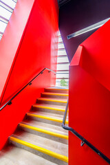 Staircase painted in red. Abstract fragment of the architecture of modern lobby, hallway of the luxury hotel, shopping mall, business center in Vancouver, Canada. Interior design.