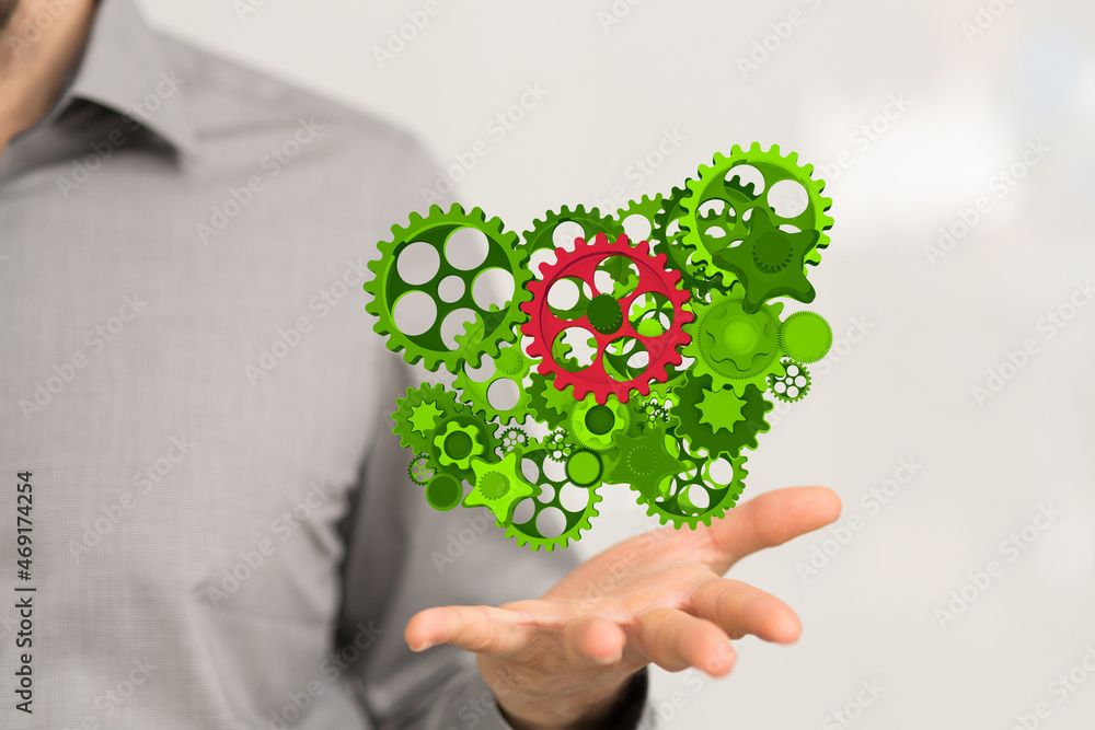 Poster above some gears and close up on three small green gears
