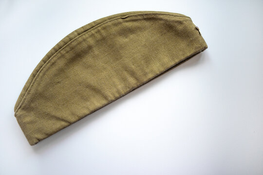 Military cap of a Soviet soldier on a white isolate. The headdress of the Soviet army. A green rag cap with a red star.