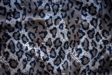 Leopard texture with round black circles. Genuine cheetah leather. Soft natural texture.