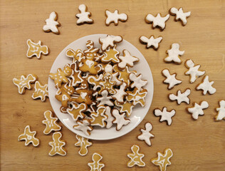 Homemade Christmas gingerbread cookies in a white plate. View from above. Festive food