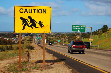A sign on the highway near San Diego, California warns drivers to beware of immigrants and migrants...