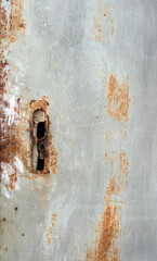 A gray metal surface with rust stains