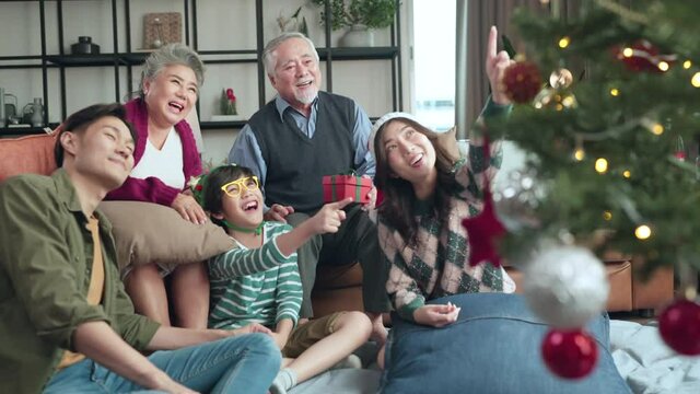 happiness asian cheerful muti gernersation family grandparent,grandchild sit relax positive emotion together at home in christmas festive decoration home,christmas weekend vacation family together 