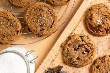 Organic food snack tasty sweet dessert milk dark chocolate chip salt cookie closeup piece fruit orange raspberry hazelnut nuts cinnamon on cocoa cacao powder wooden table for new year Christmas gift	