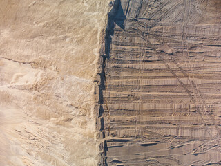 Aerial top down view of leveling ground with prints of bulldozer.