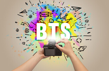 Close-up of a hand holding digital camera with abstract drawing