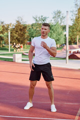 Fototapeta premium athletic men doing exercises on the sports ground in summer