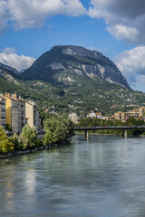 Fototapeta na wymiar Picturesque Grenoble city view and the banks of Isere river. Grenoble, Auvergne-Rhone-Alpes region, France.