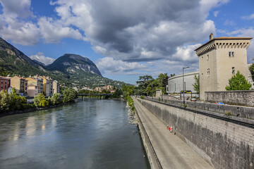 Picturesque Grenoble city view and the banks of Isere river. Grenoble, Auvergne-Rhone-Alpes region, France.
