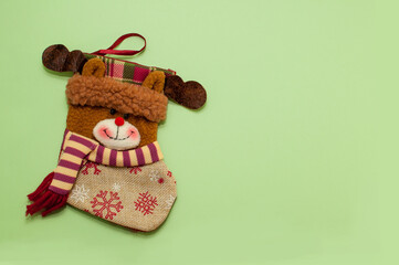 christmas sock for gifts in the form of a bear on a green background