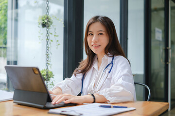 Portrait of woman doctor working with digital tablet at office. Plastic Surgery and beauty clinic concept