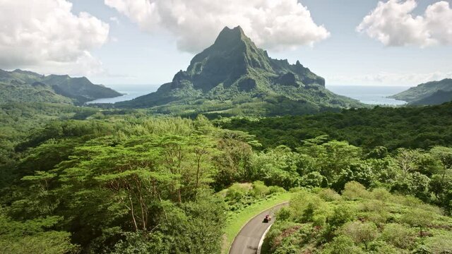 Aerial Tahiti, Drone Moorea island. Tropical green mountain jungle forest of Mount Rotui. French Polynesia luxury travel vacation, paradise getaway, romantic honeymoon exotic destination.  