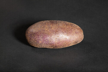 red potato on black background