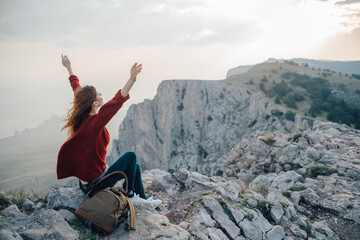 woman with backpack in mountains at altitude landscape nature