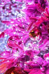 Christmas mirror evening bauble disco ball with pink fir tree and garland.