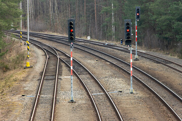 Empty tracks with red traffic lights before the turn.