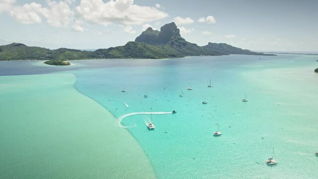 Bora Bora drone aerial view, clear water lagoon beach. Tahiti island. French Polynesia. Exotic travel vacation getaway, romantic honeymoon destination.