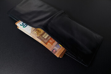 Euro banknotes in a black leather wallet