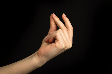 Hand gesture snapping fingers, easy sign and symbol on a black background