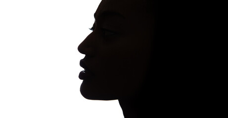 Black profile of an African woman on a white background, shaded silhouette of head. Proud woman...