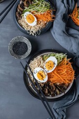 Miso ramen with mushrooms, carrots, zucchini and eggs on a dark background,top view,copy spase